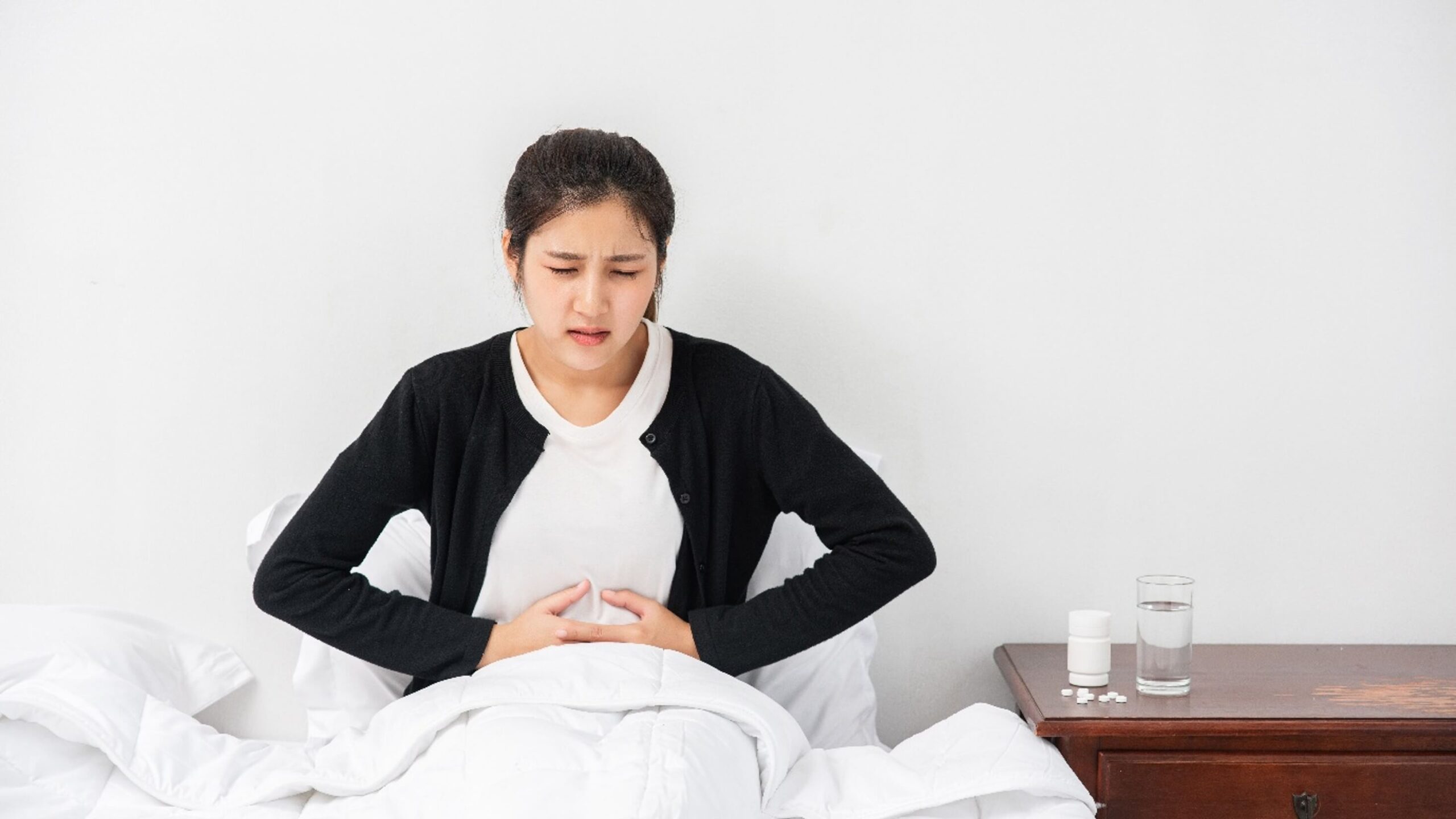 Woman experiencing abdominal bloating and discomfort.
